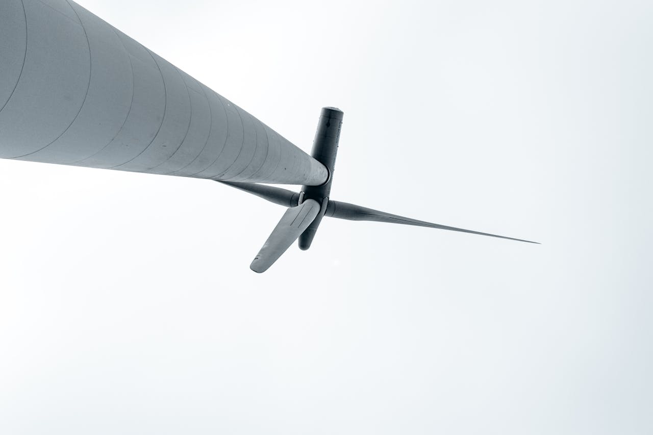 A low-angle view of a wind turbine symbolizing renewable energy and environmental sustainability.